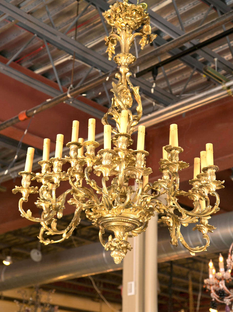 Gorgeous 1920's Bronze Rococo Chandelier - 24 Light.  Has been rewired.
Breath taking in all its beauty with rosettes, flowers, and vines swaying from limb to limb.  Attractive bronze work with a gold gilding.  Full of french elegance.  Ball