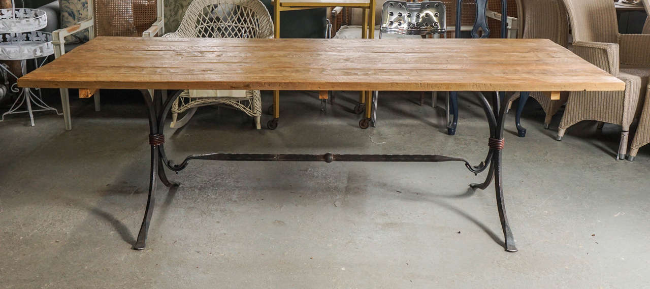 Industrial bistro style wrought iron table base with a cross beam.  Listing shown with a teak table top for photo purposes only.  Seats up to eight, possibly ten with two chairs at each end.  Table base will support a top of your choice:  stone,