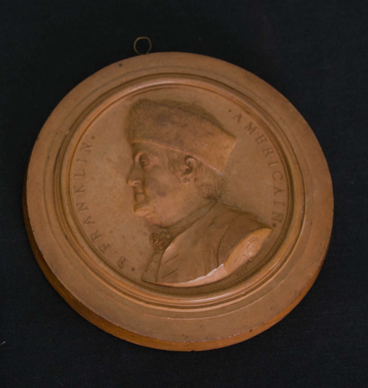 The Italian artist, Jean Baptiste (or Giovanni Battista) Nini, based his portrait of Franklin on a drawing by Thomas Walpole, the young son of an associate of Franklin. The bas-relief medallion is enclosed by a narrow moulding with the interior