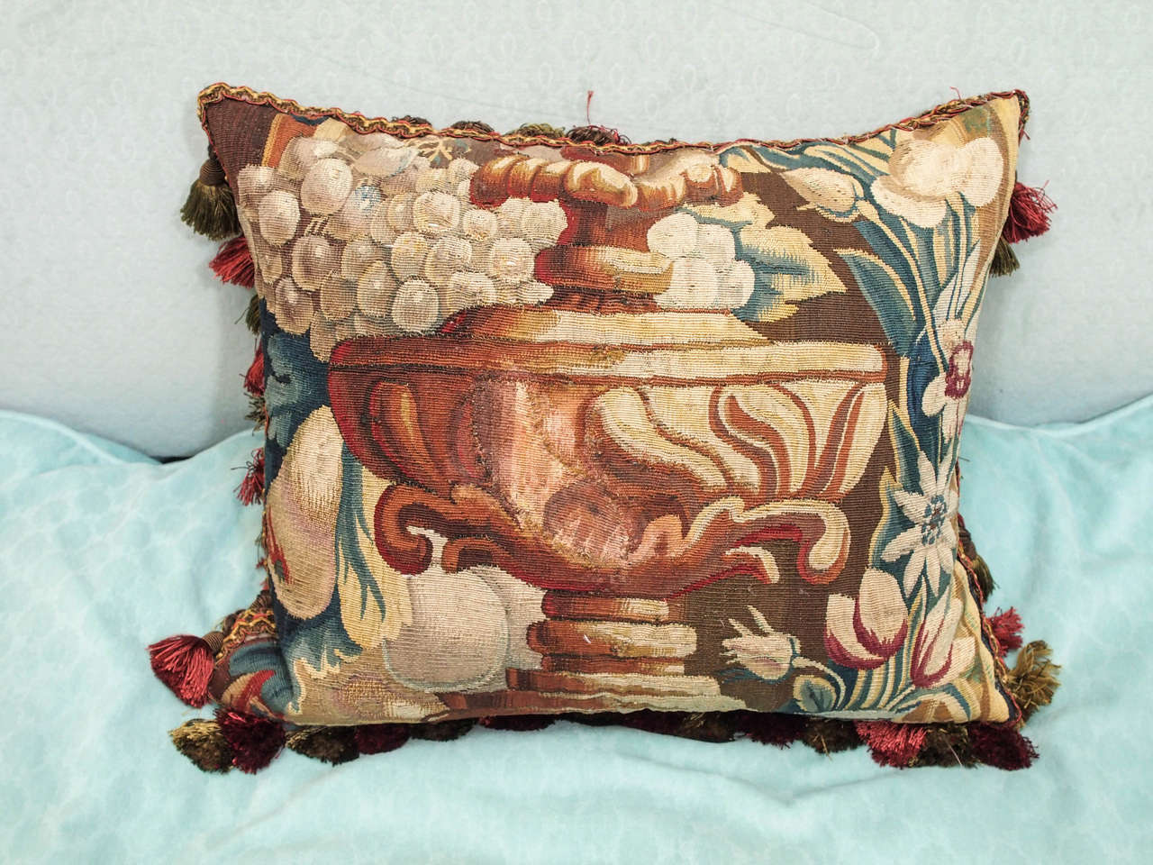 French Aubusson tapestry fragment depicting a garden urn now as a cushion with silk trim, silk velvet backing and down insert.