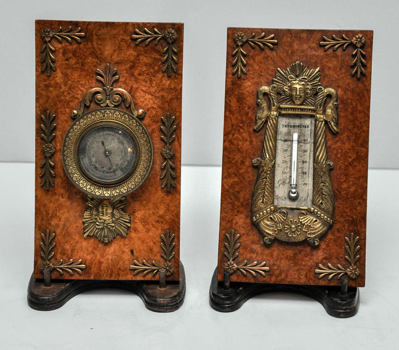 Empire mulberry wood, bronze and ormolu barometer and thermometer with silvered face, circa 1815.