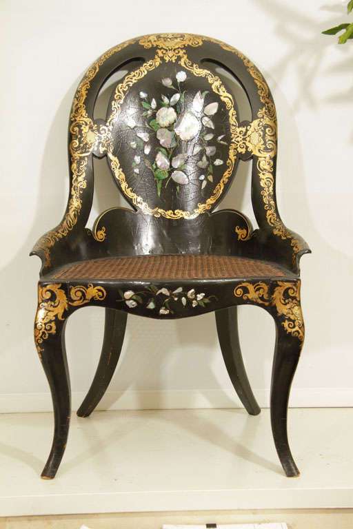 This fine mid ninteenth century English Victorian period papier mache slipper chair has a molded and shaped balloon back with mother of pearl inlay and gilded decoration, pierced scrolling, center hand painted and mother of pearl inlaid floral