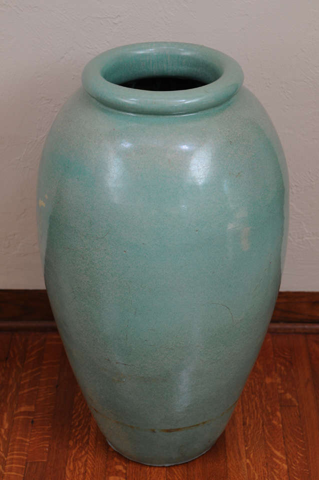 This handsome pair of American Arts and Crafts glazed pottery urns are attributed to Bauer Potter of California and date to the 1920s-1930s. Bauer was known for their amazing, colorful pottery pieces. These pieces are in a translucent, soft