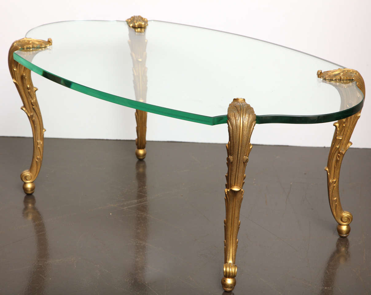 P.E Guerin 
Low table with scrolling acanthus bronze legs and lozenge shaped glass top. Signed under feet. American, c. 1950s