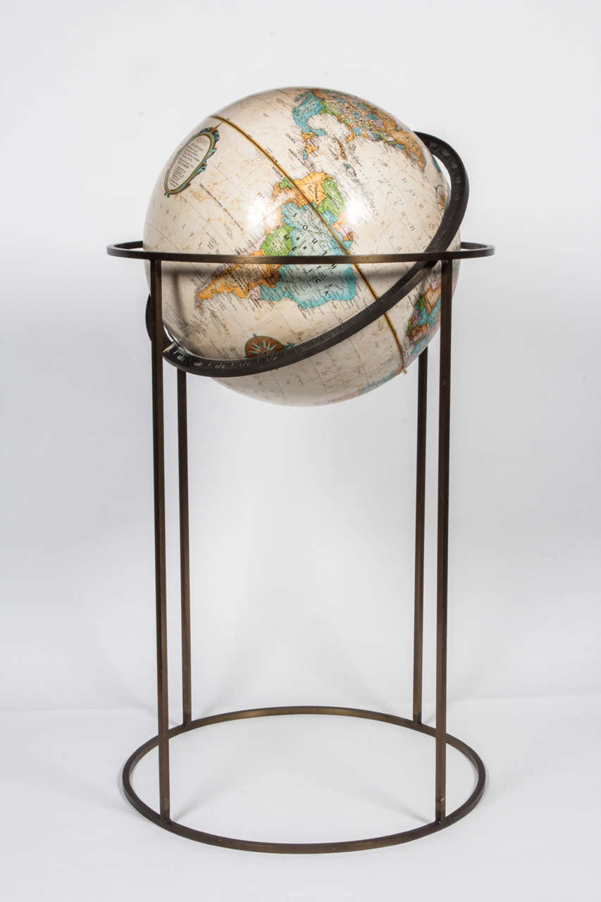 World globe by Replogle in the style of Paul McCobb, USA, circa 1970. Signed.

Beige globe supported by swivel stand in antiqued brass. Featuring square tube design made popular by McCobb.