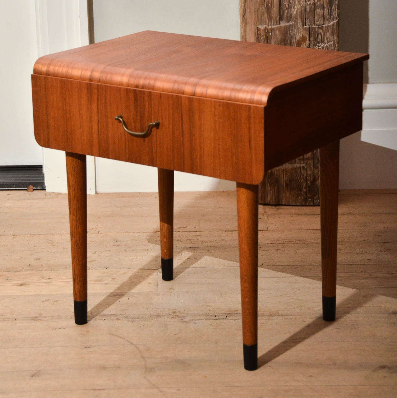 Beautiful pair of midcentury teak side tables in the style of Severin Hansen Jr. with one wide drawer and brass handle.