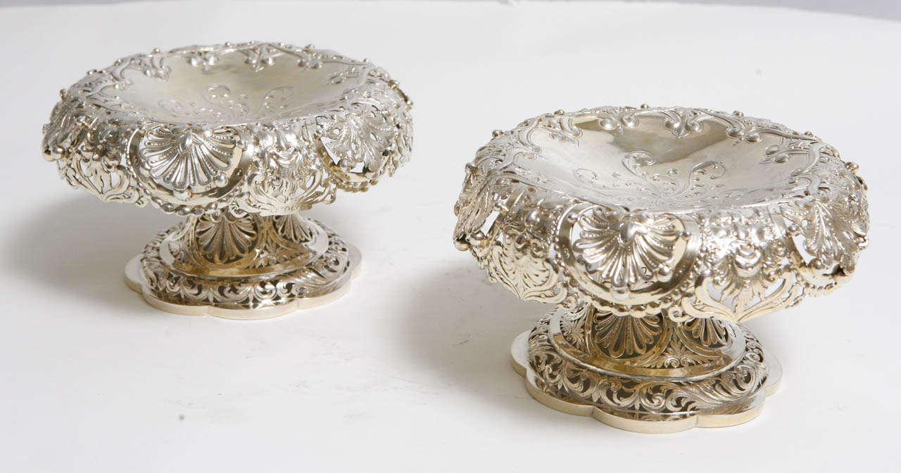 Pair of 18th century English Sterling Compotes with Gold Wash.  The compotes are very finely chased and are hallmarked. The base diameter is 6 inches.