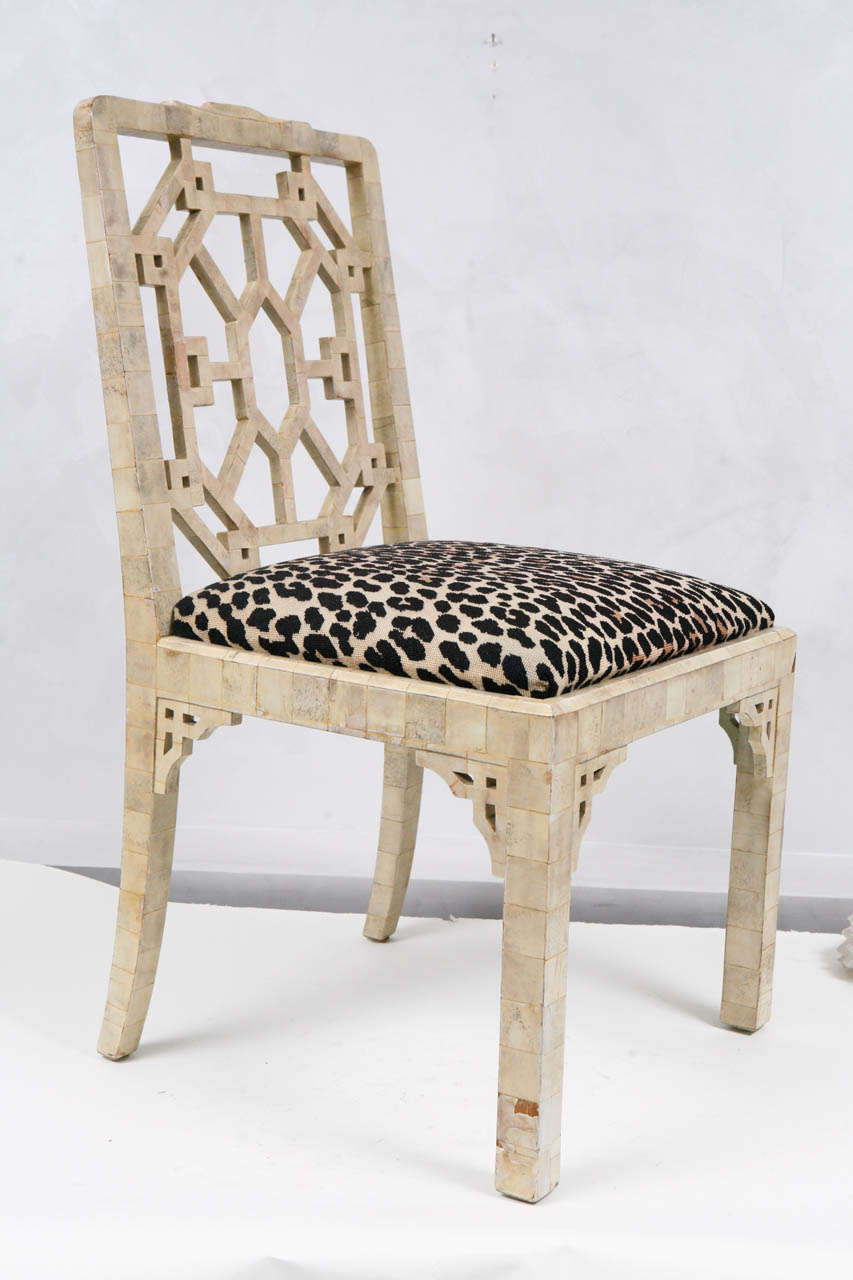 Group of four 1960s bone veneered Chippendale style side chairs with needlepoint animal print seat.