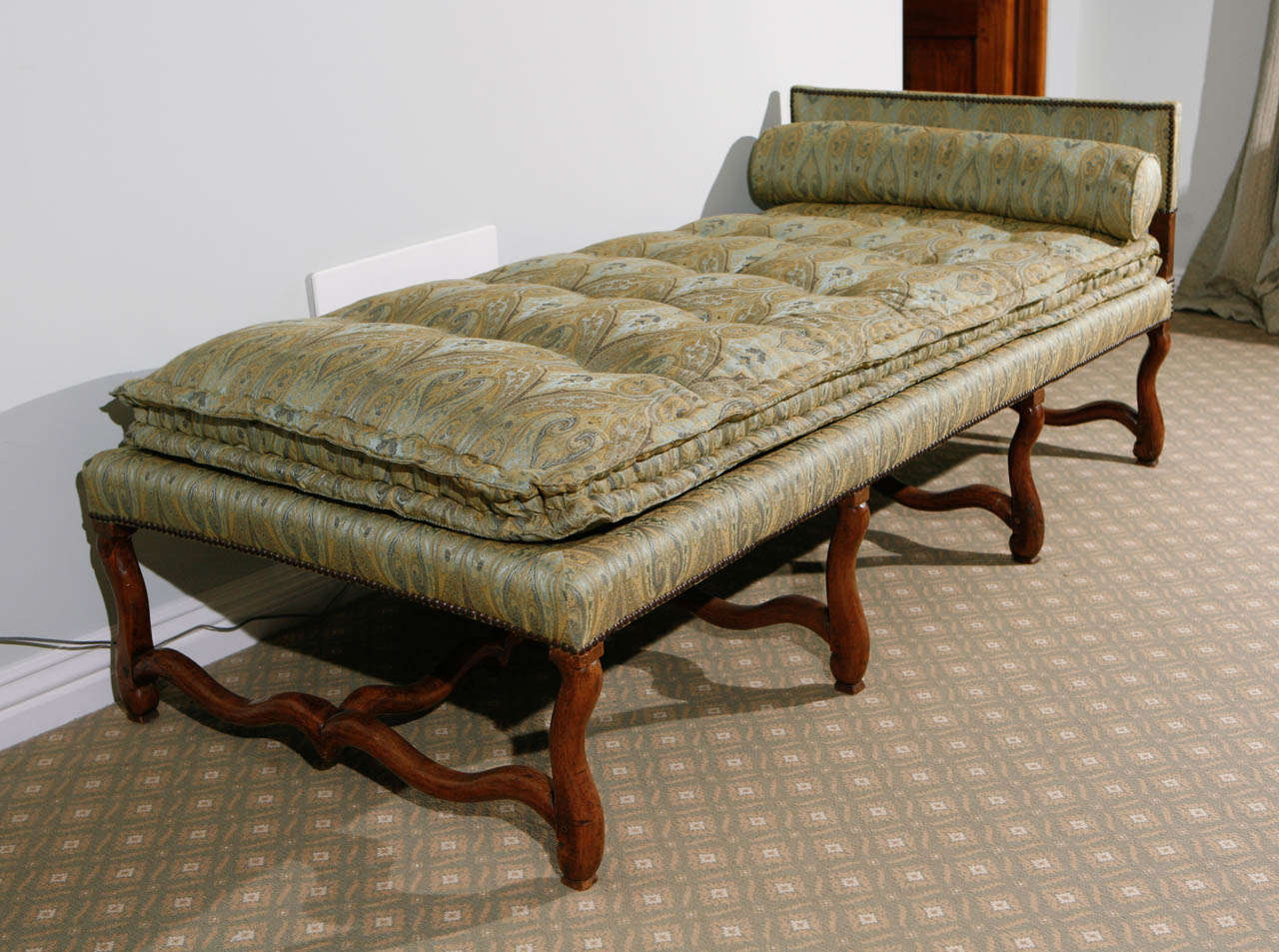 18th century French Walnut Os du Mouton Chaise.  The Chaise has been upholstered in green paisley silk fabric.  The head board measurement  is 27.5 inches high.