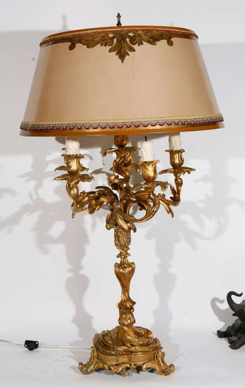 Pair of very fine 19th c. French Dore Bronze Candelabras converted to Lamps. The Shades are included and are Hand Made of Parchment Paper. They are Hand Gilded and Decorated. The lamps have been newly wired. The base measurement is 9 inches.