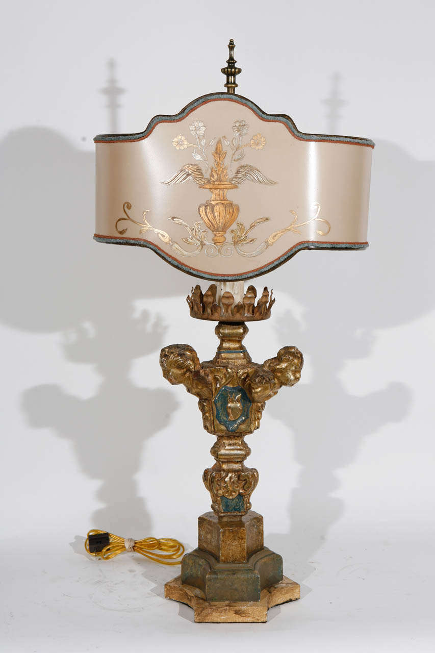 Single 18th c. Italian Giltwood and Polychrome Candlestick with Cherub Heads converted to Lamp. Base measurement is 7 inches. The Shade is included and is Hand Made of Parchment Paper. It is Hand Gilded and Decorated. The lamp has been newly wired.