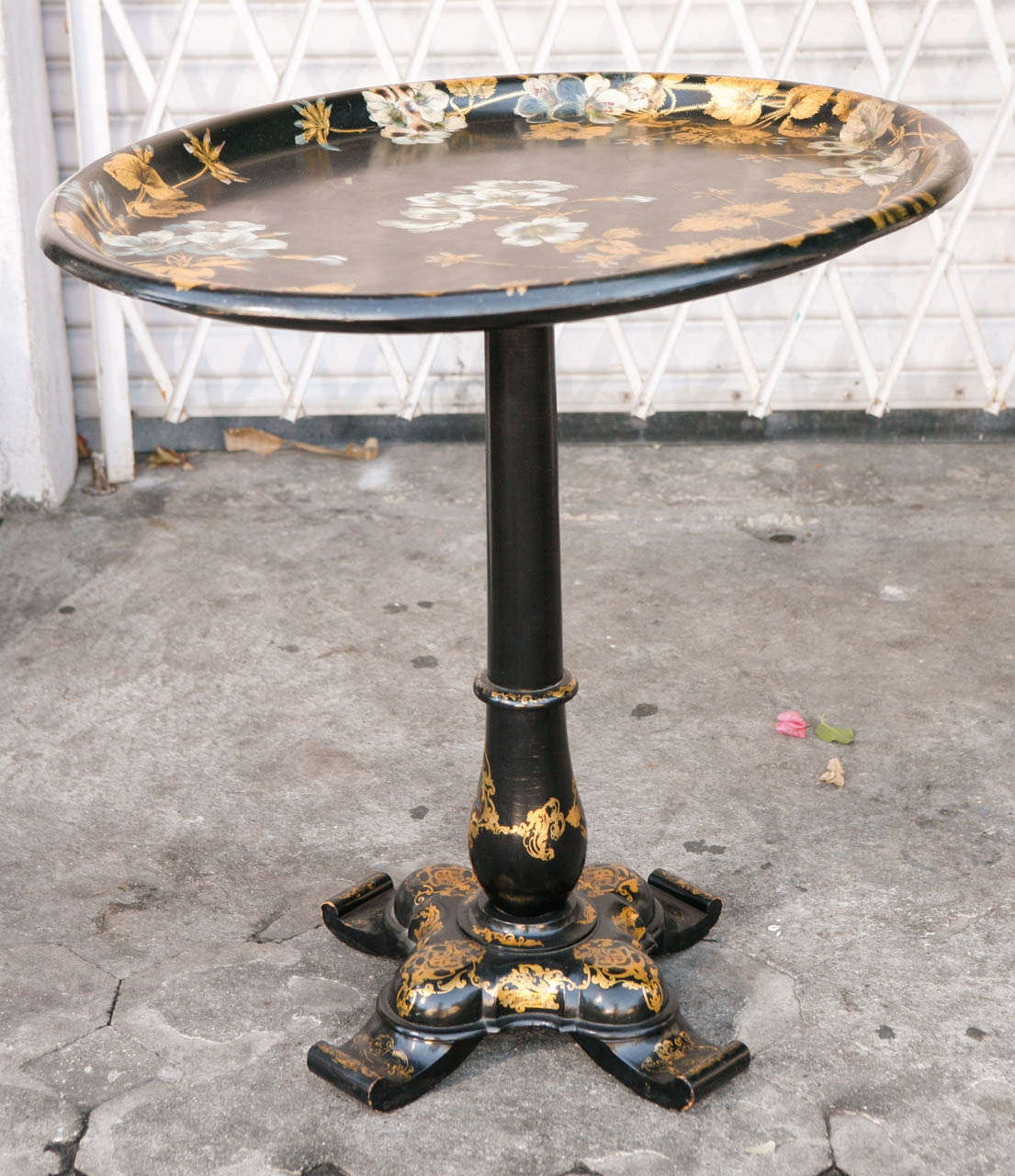 19th century French papier mâché flip-top tray table.  It is hand painted and gilded. The base diameter measurement is 17 inches.