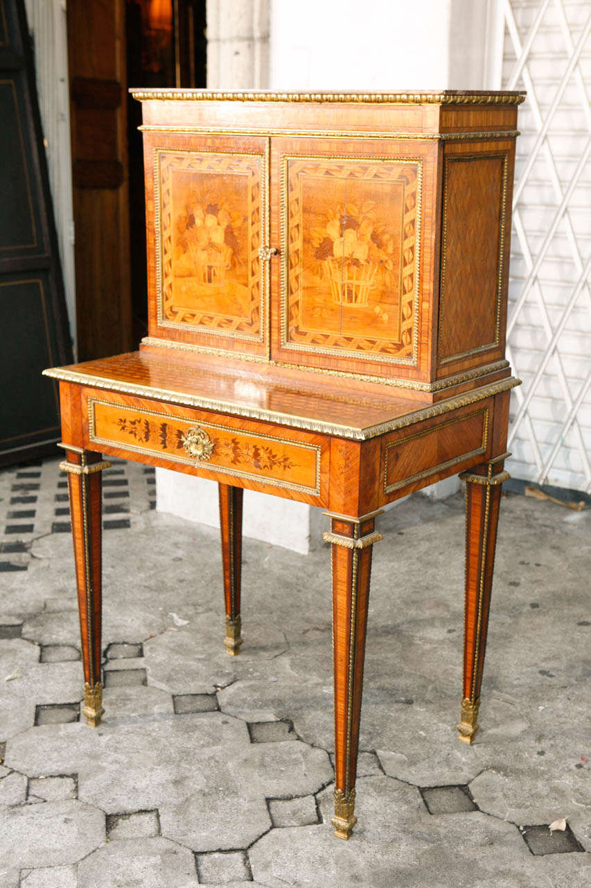 Very fine late 19th century French writing desk secretary with dore bronze mountings and Marble.  It is made of a variety of woods - fruitwood, satinwood and walnut. The overall measurement of the desk is 49 inches tall.  The desk measures 29.5