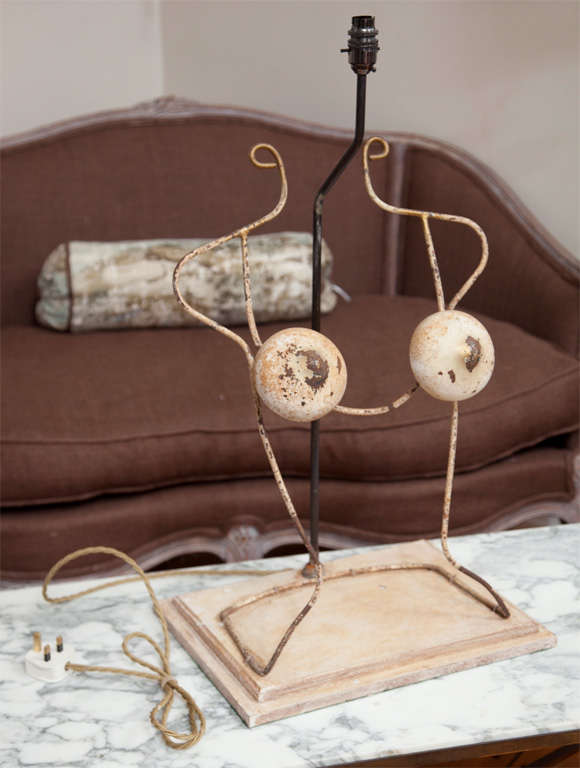 We absolutely adore this funky wrought iron form and the anonymous visionary who transformed it into a lamp! Originally a blouse form from a French haberdashery, it makes a great accent piece on your favorite side table. Presently wired for France,