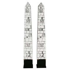 A pair of metal enamelled obelisk Lamps by Piero Fornasetti.