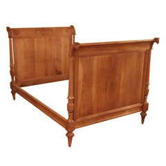 Antique French Charles X fruitwood carved bed.