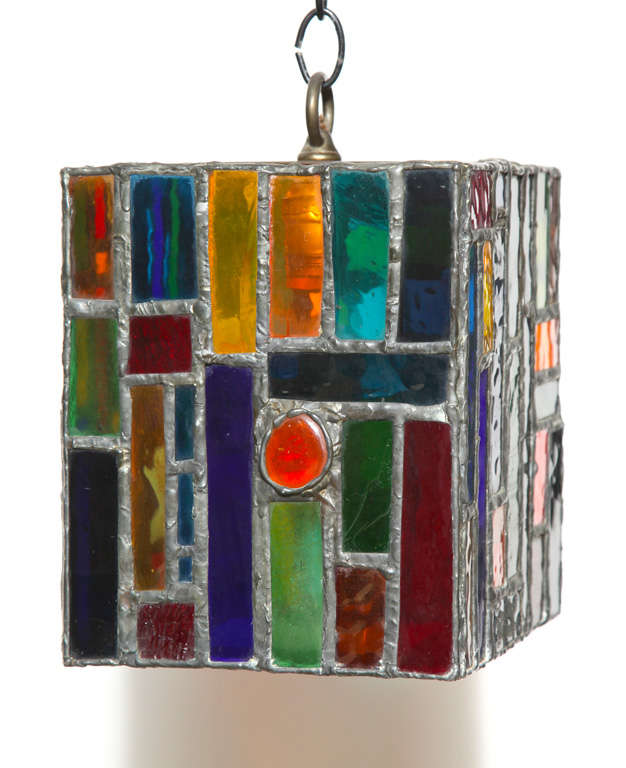 American Mid Century Hand Crafted Adjustable Bright Stained Glass Hanging Lamp. Featuring a handcrafted slightly Silver leaded rectangular form with rounded rectangular stained glass pieces in Blue, Green, Red, Orange and Yellow. With Brass Cross