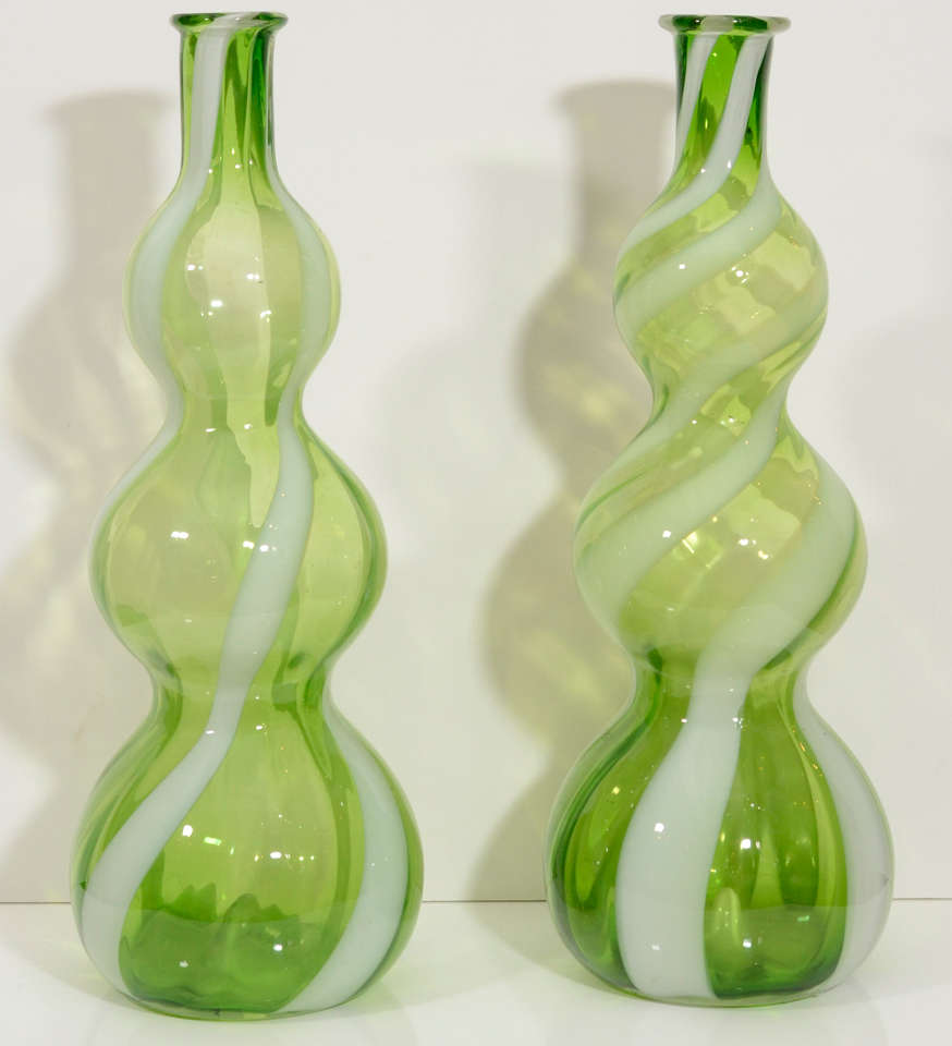 A pair of sculptural glass vases in a chartreuse color from the Empoli region of Italy.