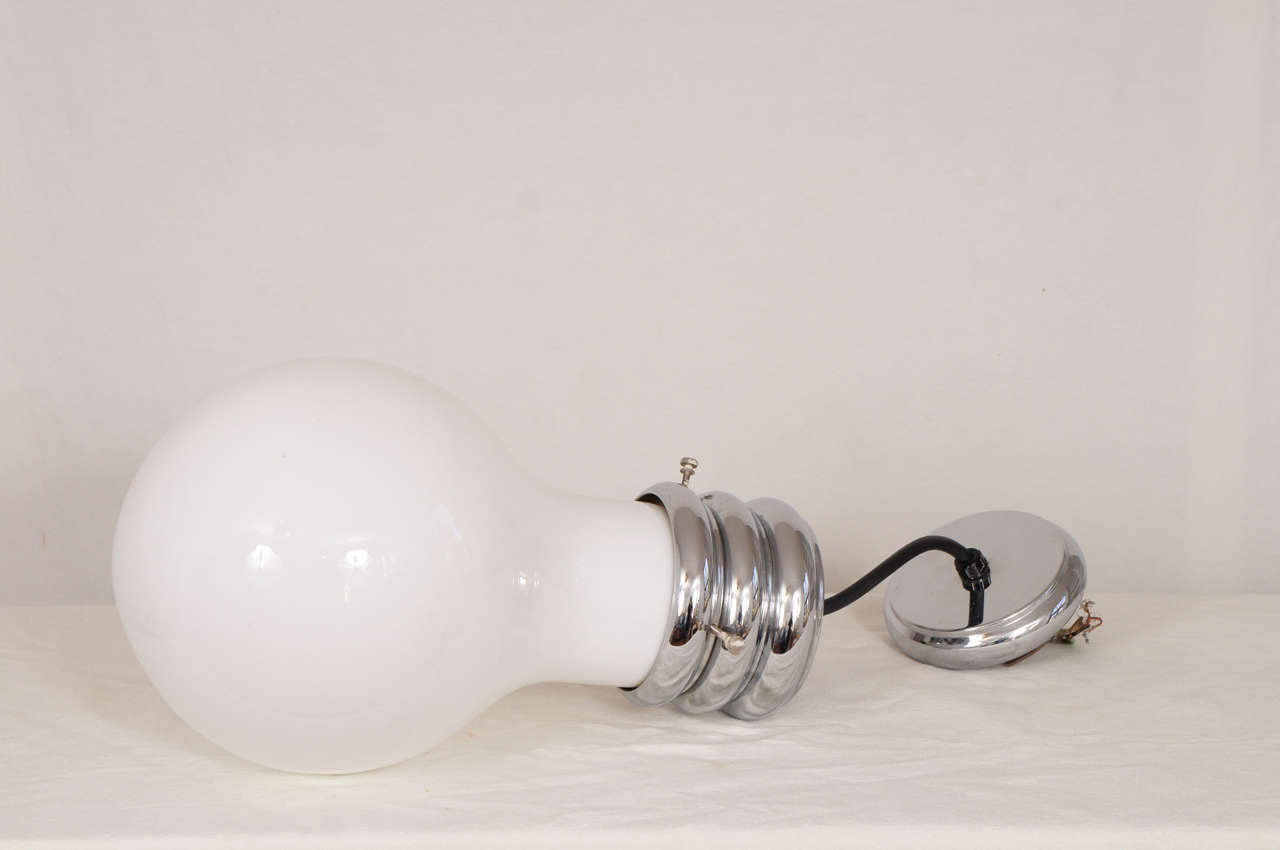 This is a fun light. the design is a large light bulb.
glass fixture with a chrome socket.
its in fantastic condition. would be really fun in a childs room.