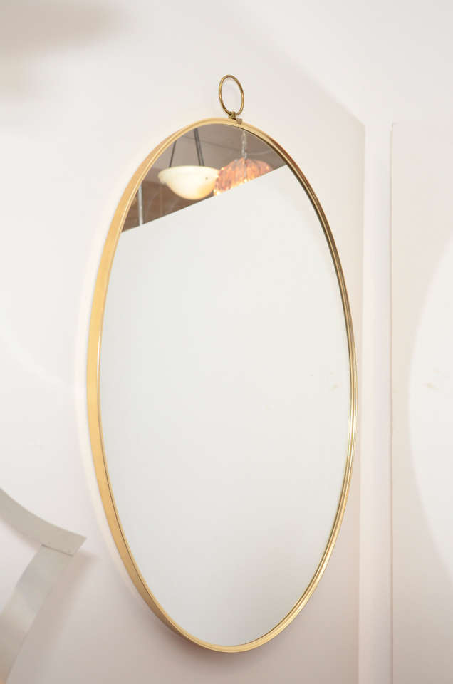 American 1960s Graceful Oval Brass Mirror with Finial Detail