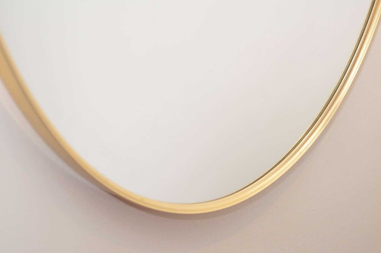 1960s Graceful Oval Brass Mirror with Finial Detail In Excellent Condition In New York, NY