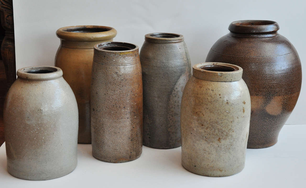 This 6 piece collection includes 5 stoneware jars for canning and food preservation and 1 large molasses pot.  These are from the late 18th / early 19th C and feature beautiful salt glazes.
Approx Dimensions From Left To Right:
1: 8