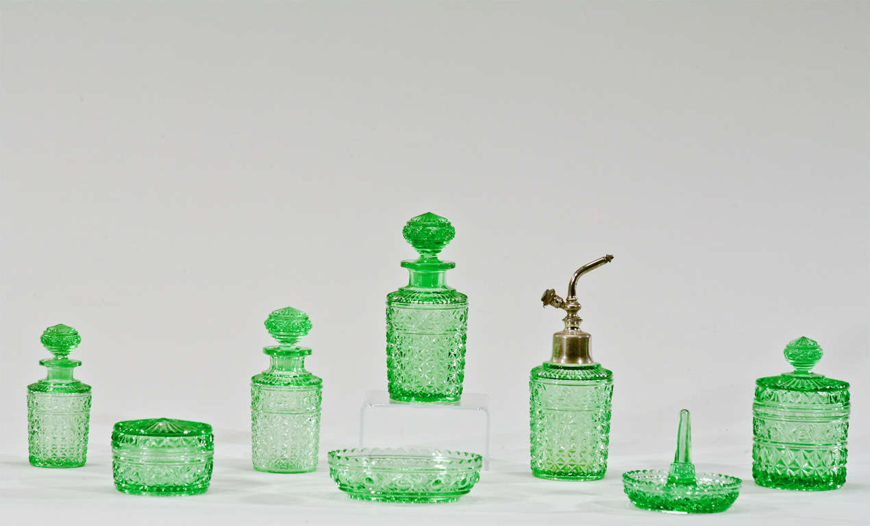 This lovely 8 piece dresser set was made by Val St.Lambert and includes the whole array of pieces for a dresser or vanity mirror. 3 perfume bottles, an atomizer, ring dish, soap dish and 2 covered boxes. It is made in molded crystal, a technique
