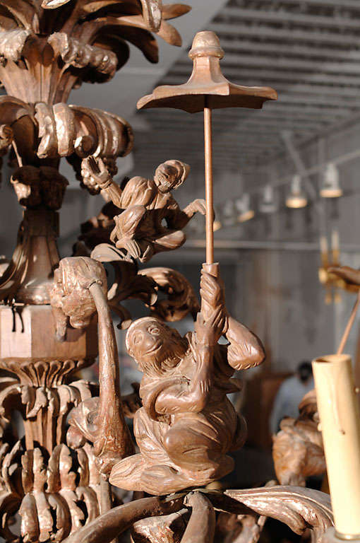 Wonderfully carved 12 light, wood chandelier, with seated monkeys with parasols.<br />
**needs to be rewired<br />
<br />
<br />
View our complete collection www.hollisandknight.com