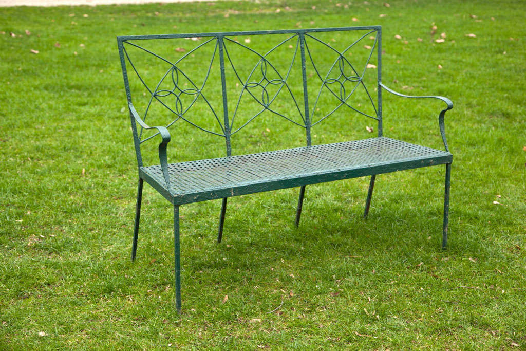 A wrought-iron seat with repeating arc motif on the back and basketweave seat, by Joseph J. Leinfelder & Sons, Lacrosse, WI.<br />
<br />
This particular pattern appears in the Leinfelder catalogues of 1935 and 1936. The 1936 catalogue describes