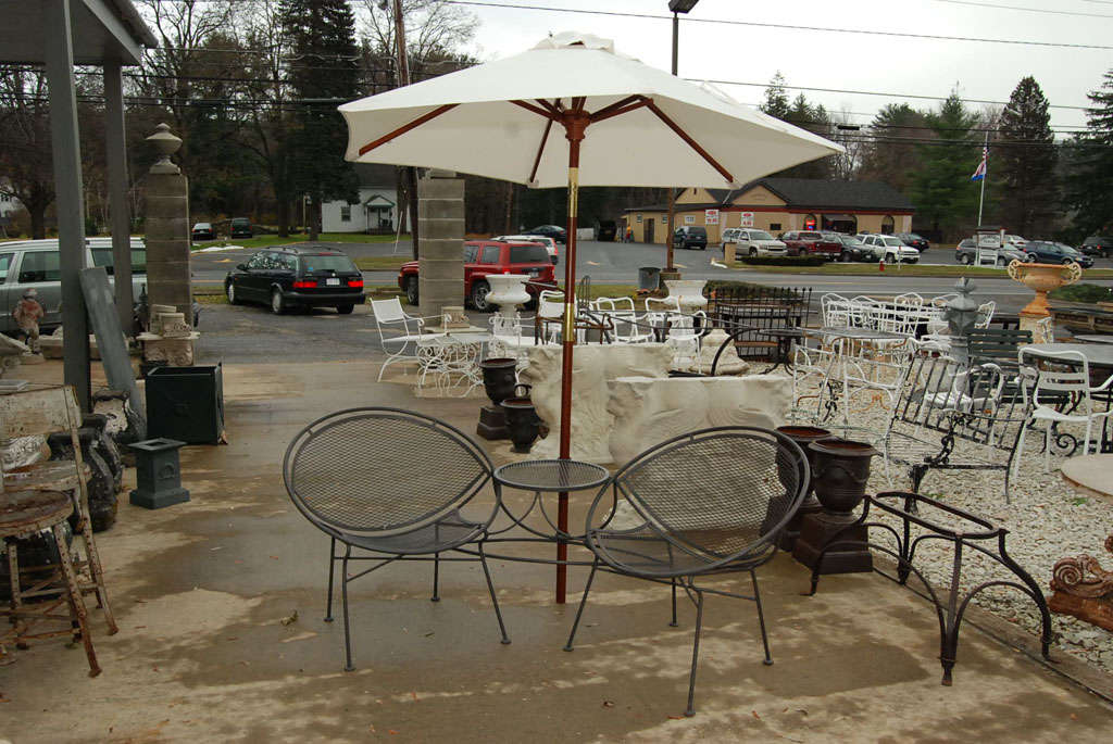 Mid century modern Woodward wrought iron radar chairs with connecting central table and umbrella holder.<br />
<br />
Keywords:  Outdoor seating, outdoor chairs,