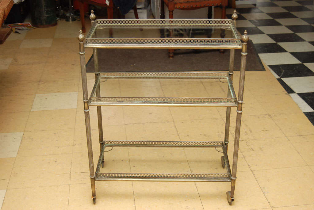 3 tiered neoclassical removable gallery glass tray cocktail serving cart on wheels.  Hollywood Regency and Empire Design Elements, Art Deco Fender Wheels, fluted column legs.  <br />
<br />
Keywords:  side table, end table, trolley, mid century,