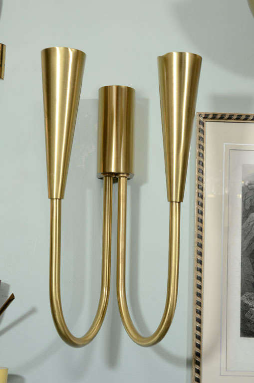 One of two pair of machine age sconces designed by Ugo Pollice in 1939. Each arm holds one bulb. Newly polished and lacquered. Two pair available. Priced 
$1,800.00 per pair.