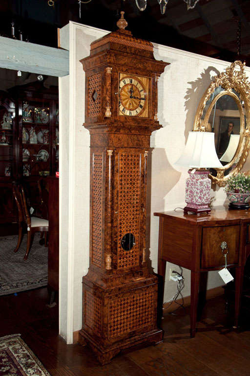 A tour de force in cabinet design and construction, this burled walnut tall case clock took four months to build.  Made from American black walnut, the case was then covered in English burled walnut.  The turned capitals and pediments, as well as