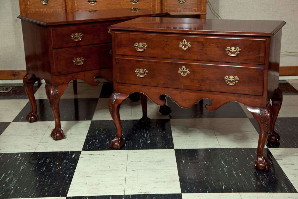 A beautiful pair of English two drawer lowboys in yewwood and of surprisingly generous proportions. With classic Chippendale design elements and in a warm, honey color, these two tables would serve well in a variety of settings, be it front hall,
