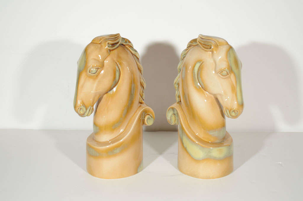 Pair of Mid-Century ceramic knight horses with a patinated putty glaze finish. Highly stylized and great looking from every angle.