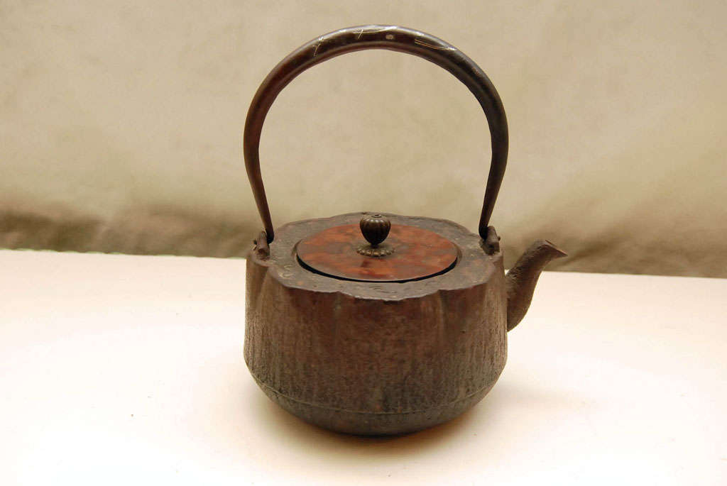 Lotus form Japanese teapot, with elegant silver inlay on handle, and acid etched bronze lid. Artist/crraftmanship signature is on interior of the lid. A playful 19th century form, with great patina.