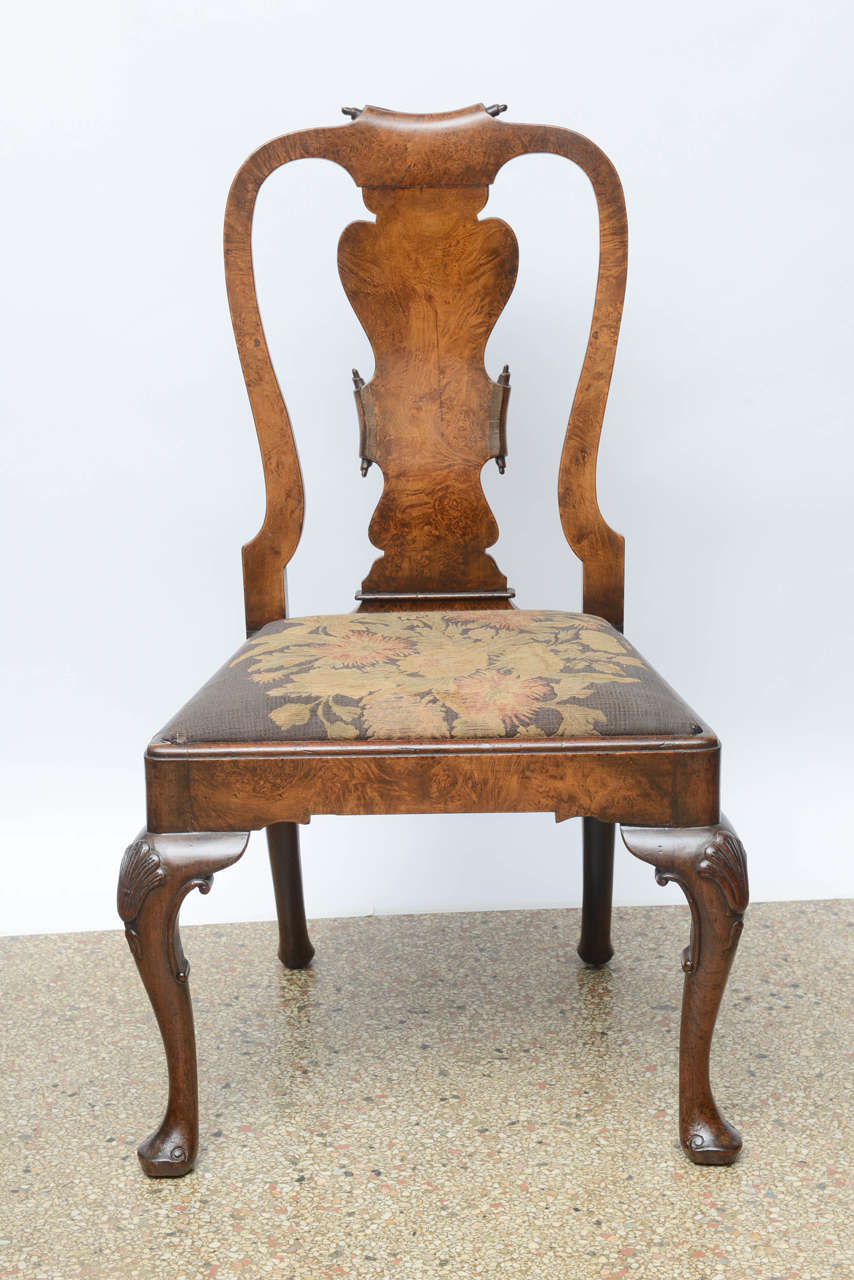 Rare and unique to find a set of six chairs of this quality. The chairs have a wonderful shaped back all hand-carved in burl walnut. The slip seats are removable and could recovered, the needlepoint is only on five of the chairs although it