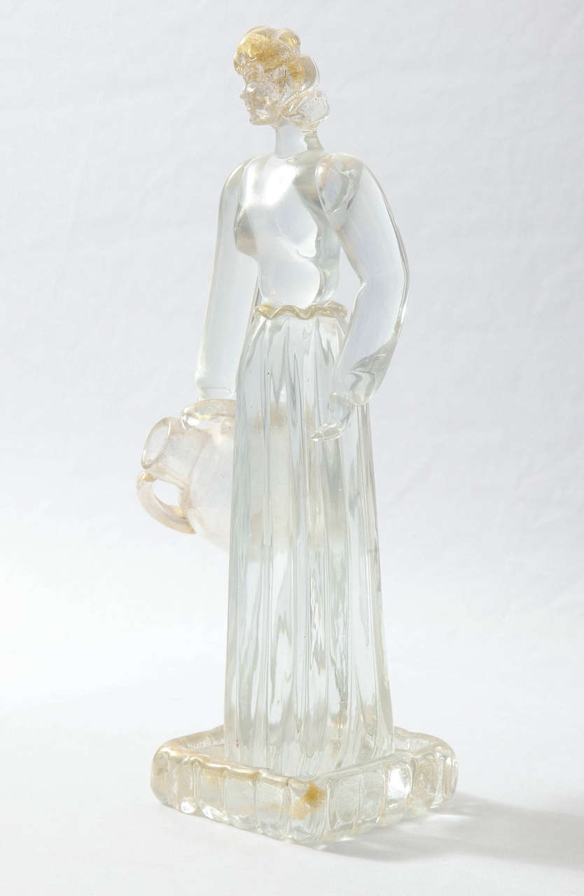 Glass figurine designed by Ercole Barovier (1889-1974) and executed by Ferro Toso Barovier (former name of Barovier e Toso) glassworks in Murano, Italy.
Iridescent clear glass with gold foil. Period round factory label under the base (see last