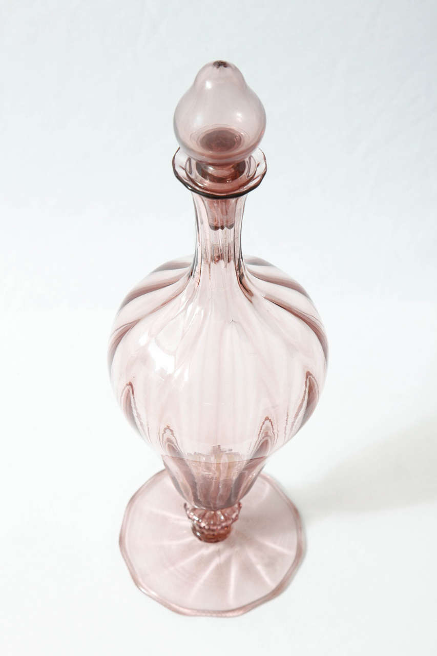 'Soffiato' bottle in light purple blown glass with applied details designed by the Italian artist Vittorio Zecchin (1978-1947) and executed by Venini, glassworks in Murano, Italy.
Venini (manufacturer) and Compagnia Venezia Murano (retailer) acid