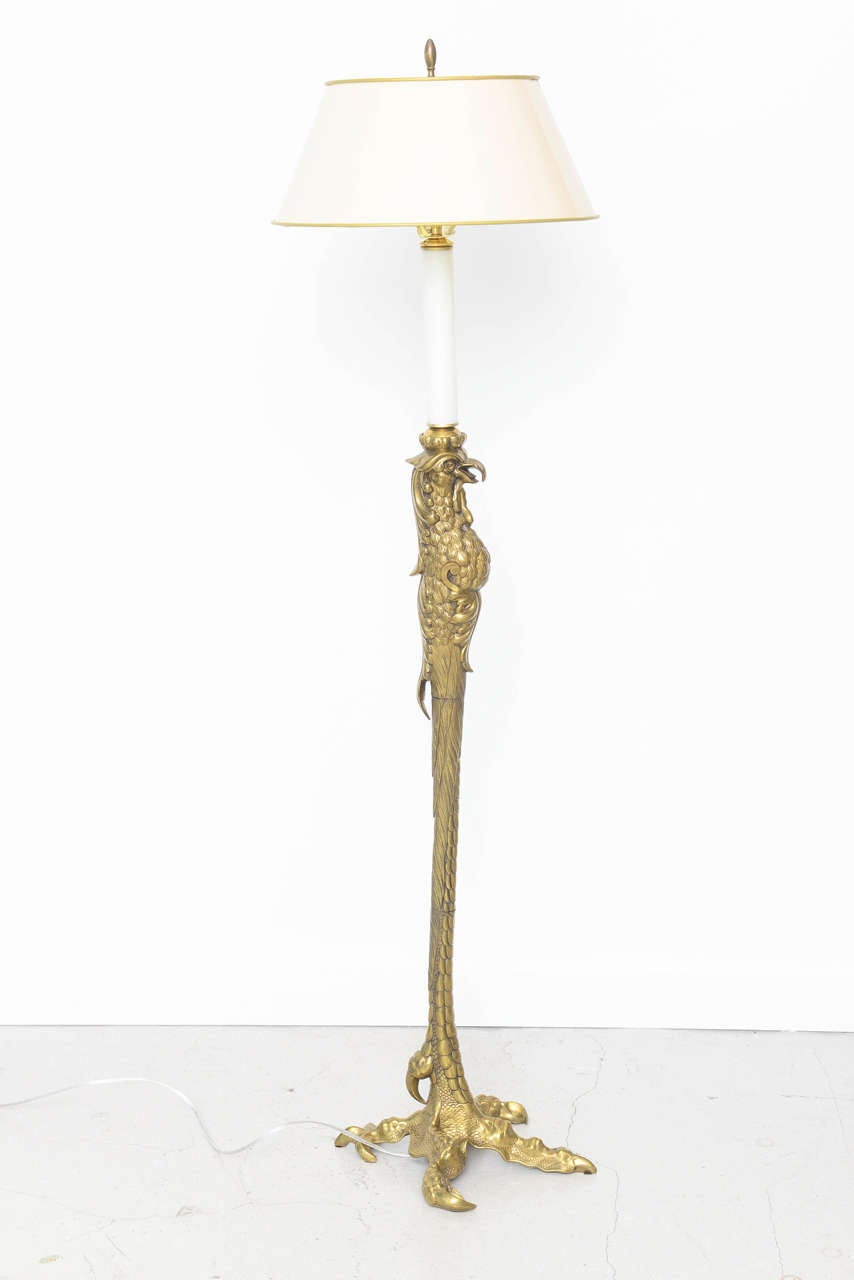 Single brass floor lamp with an eagle motif stamped by French maker P.E. Guerin.