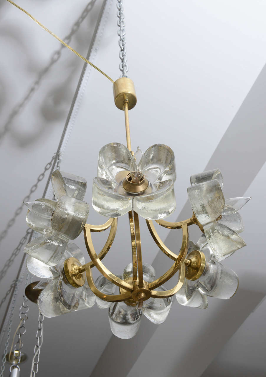 Vintage brass Mazzega chandelier featuring three-dimensional glass flowers surrounding each of the six sockets.