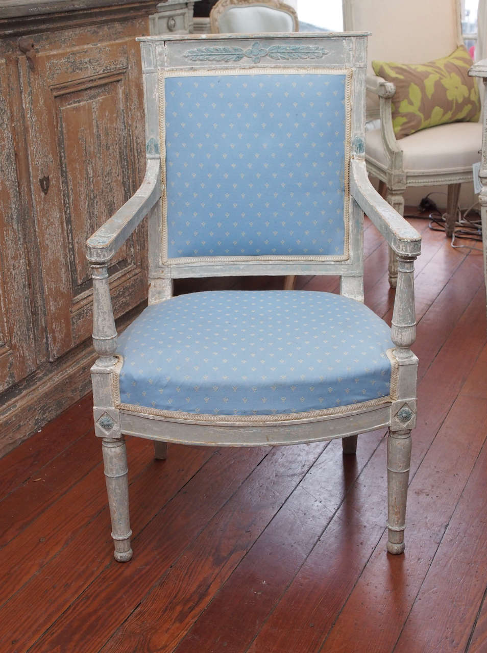 Pair of painted directoire fauteuils in pale gray and blue. Flower and leaf center medallion motif. Original paint. Circa 1795
Needs new upholstery