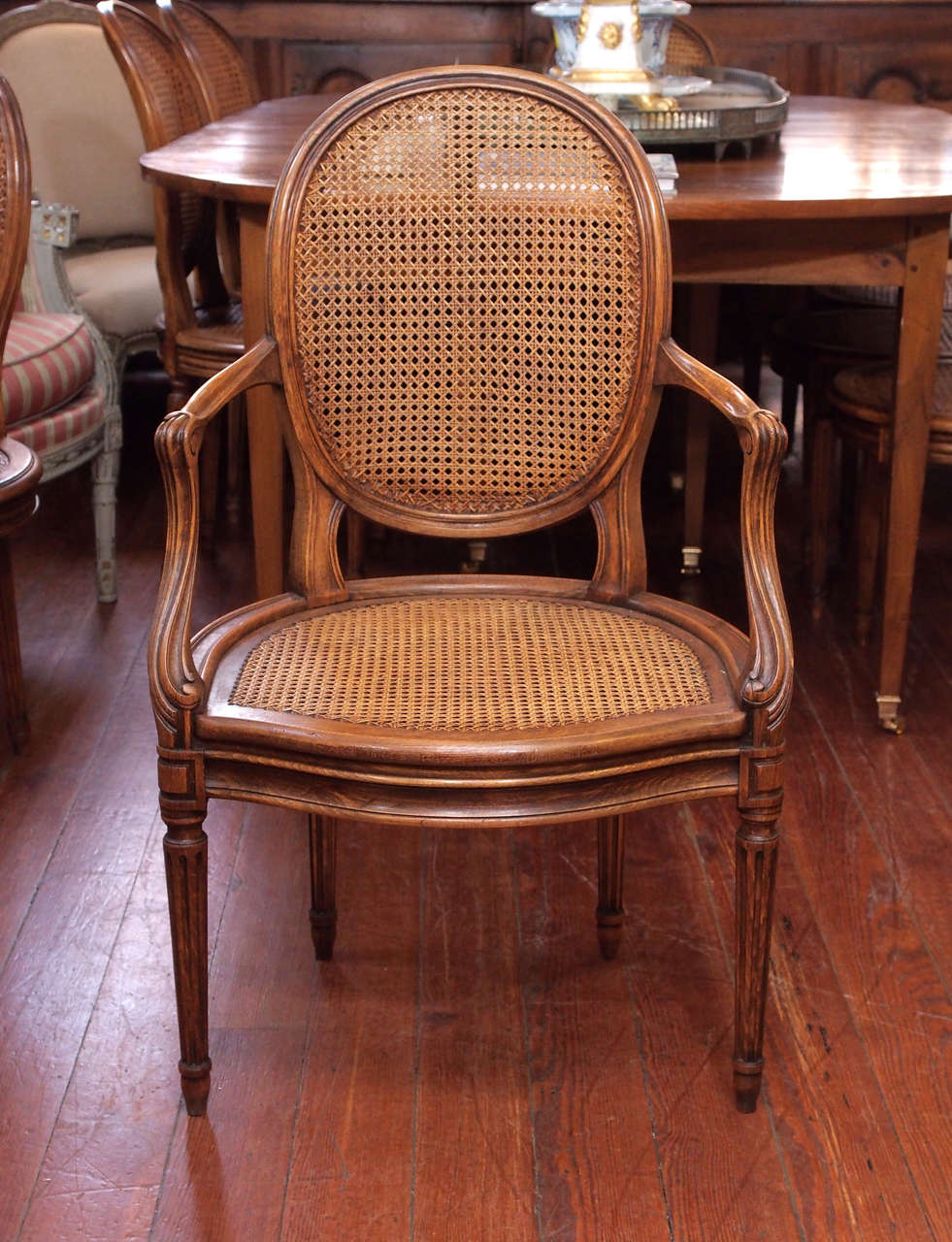 Set of ten walnut caned Louis XVI style dining room chairs. Eight chairs and two armchairs. Excellent condition.