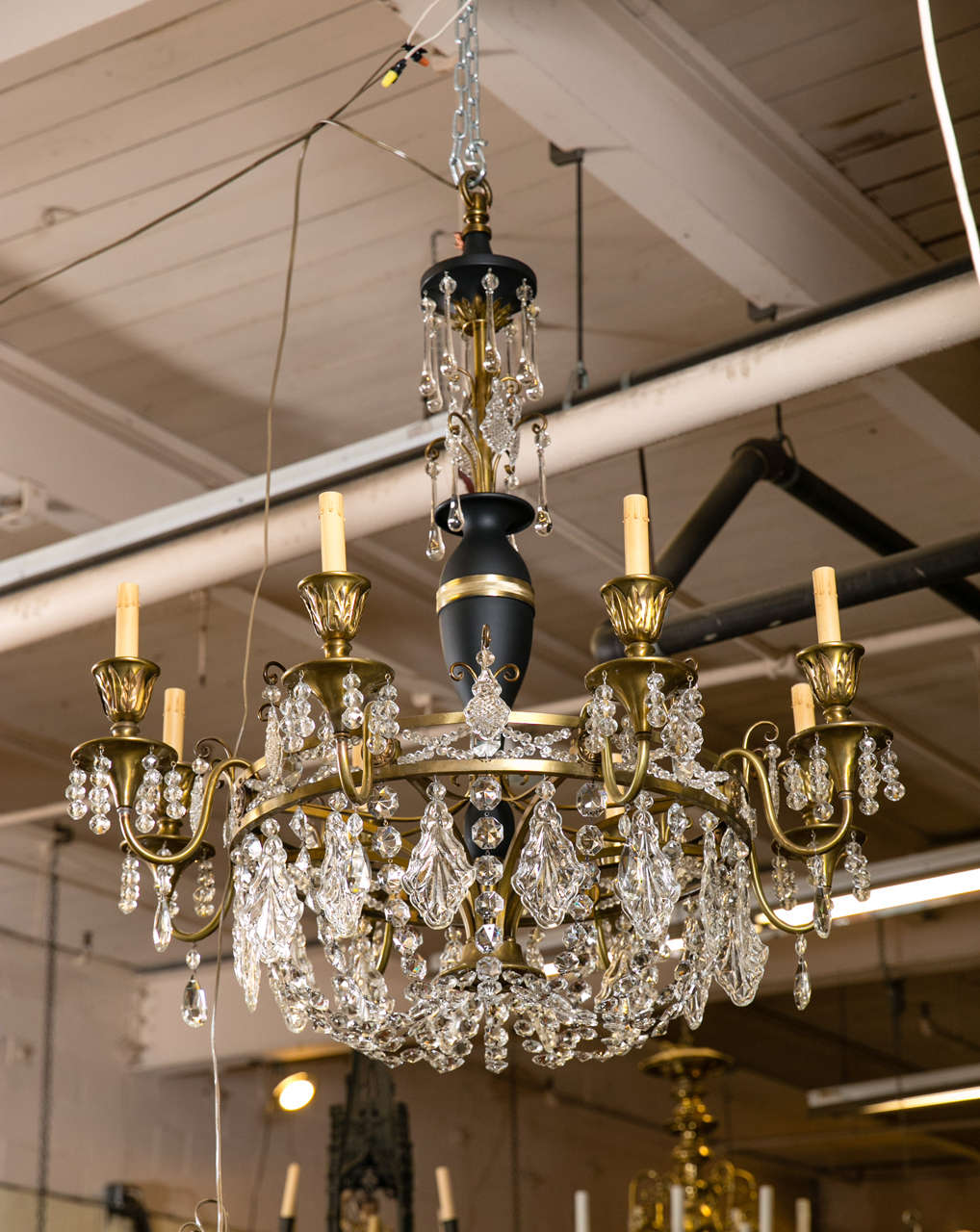 This is a gorgeous example of empire lighting.  This chandelier showcases exquisite details in elegant empire style.  There are 16 skirted bauble necklace strains and 8 arms with brass bobeches.  This chandelier is decorated with sparkling crystal