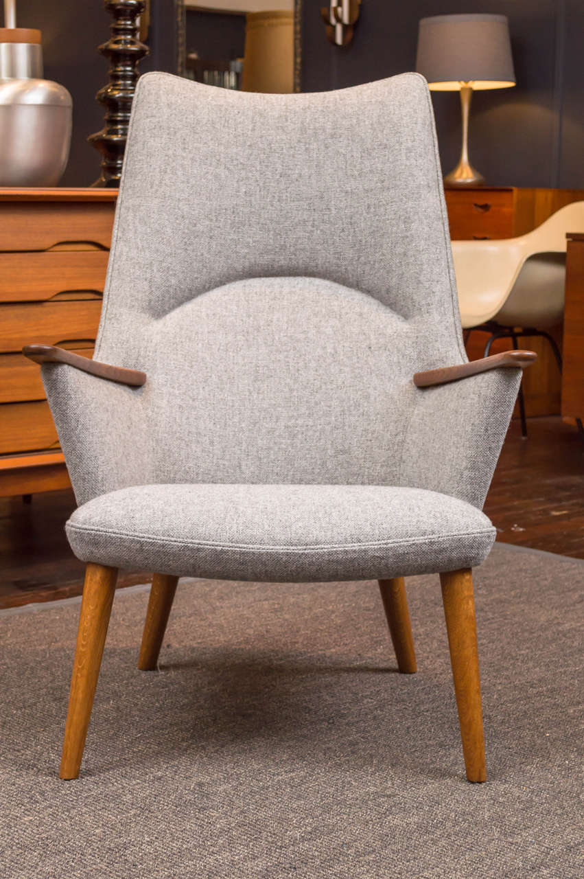 Han J Wegner design high back lounge chair for A.P Stolen. Perfectly refinished and newly upholstered in Danish light gray wool.