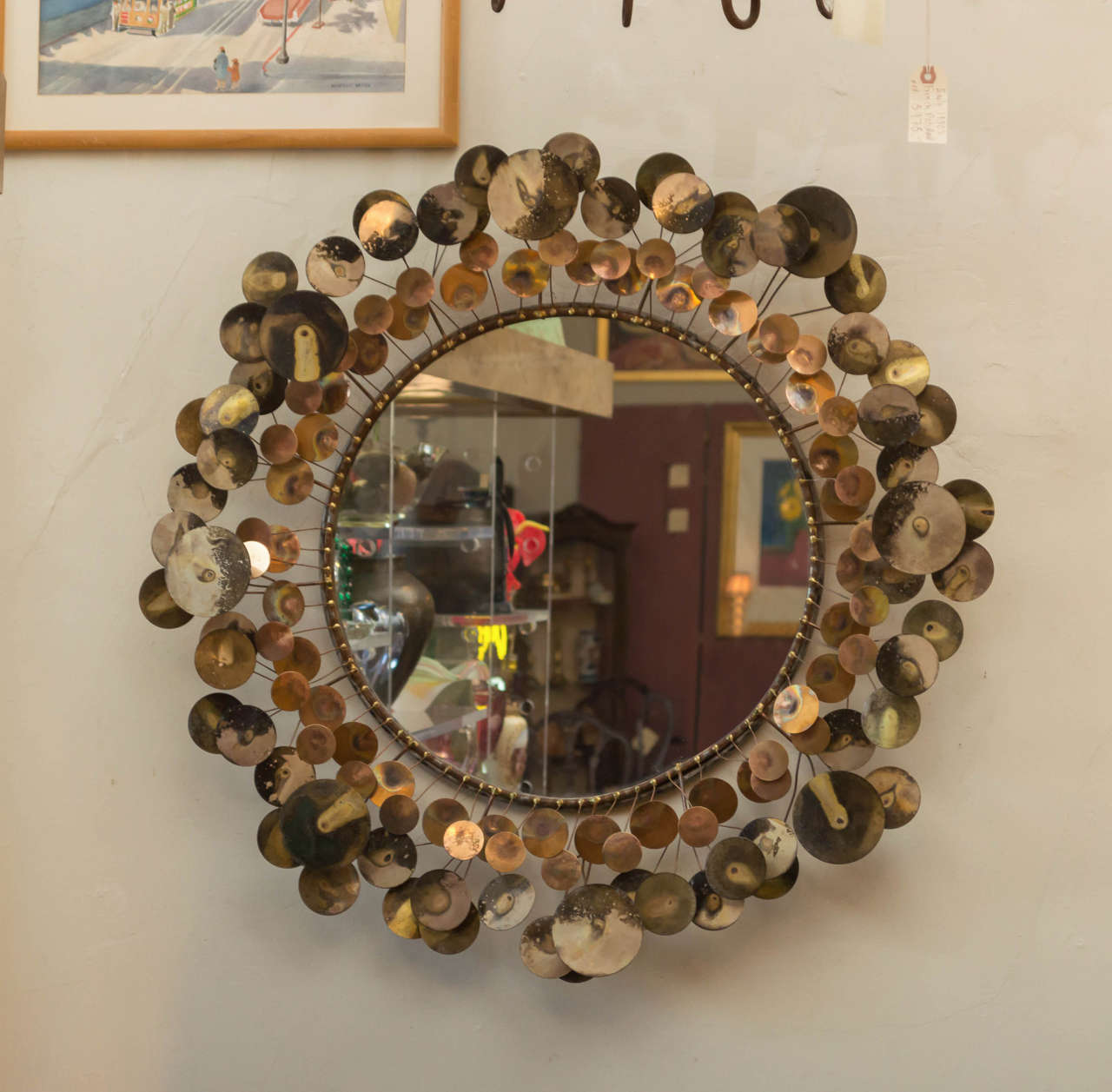 A large vintage wall mirror by C. Jere, signed on a petal, top right. Known as Raindrops, the brass has a very nice patina that only comes with age. A wonderful mirror that works well with all styles.