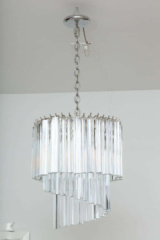 Fine Italian chandelier with cascading crystal prisms. Original heavy gauge chrome chain and chrome canopy are included. This chandelier is elegant from every angle and looks great in a myriad of settings. Simple and elegant.