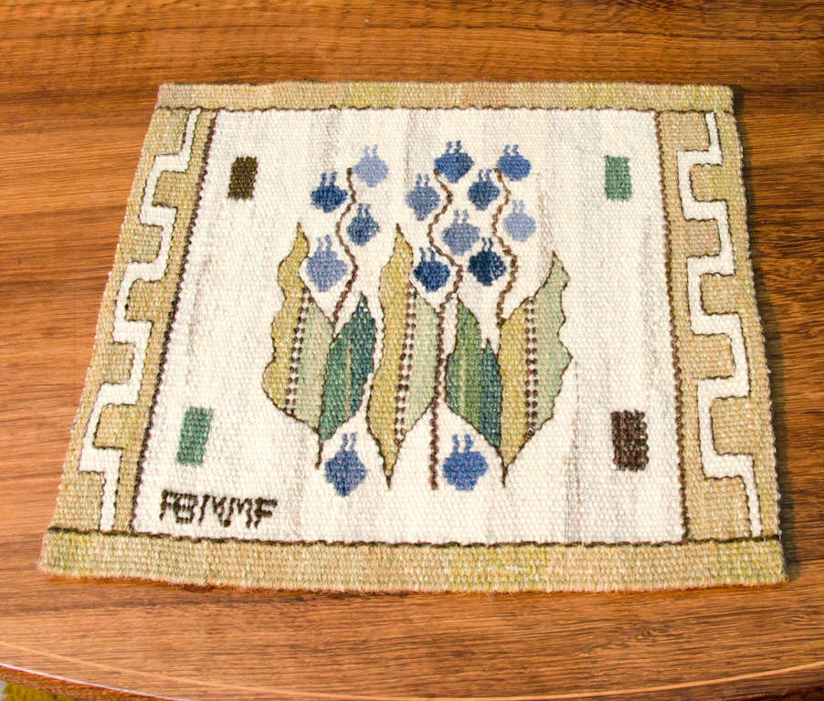 Marta Maas-Fjetterström handwoven wool wall hanging. Pattern of bluebells woven on off-white ground, set within a golden border with Greek key motif.