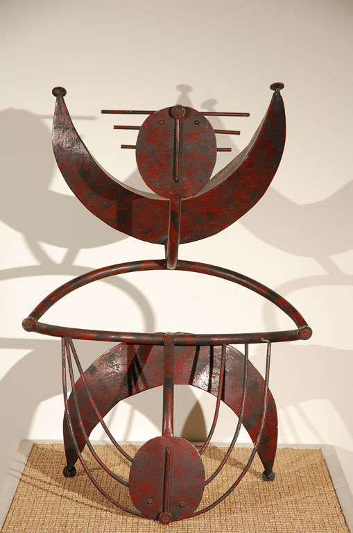 Painted old-red metal sculpture.