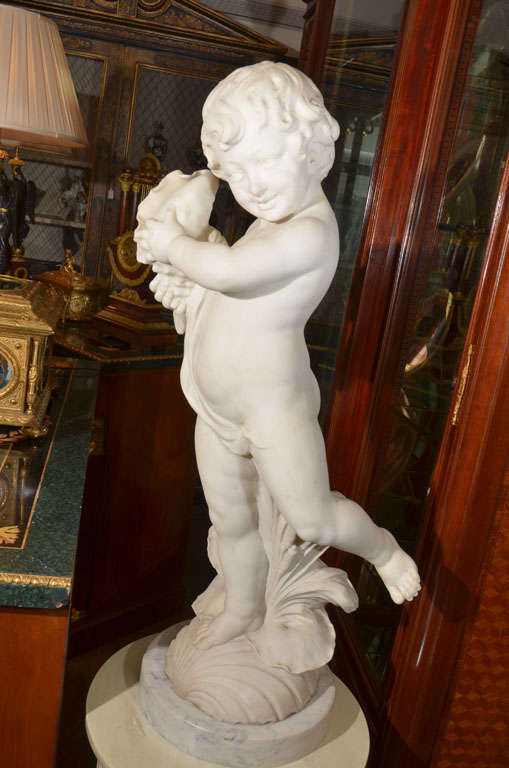 Italian 19th c Carrera marble cherub holding a conch shell